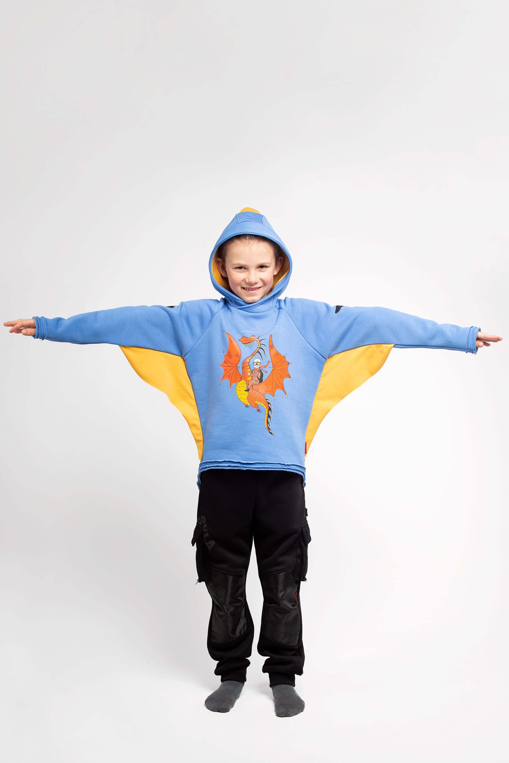 Kids Hoodie Dragon. Color sky blue. 
Technique of prints applied: silkscreen printing, picture glowing in the dark  The color shades on your screen may differ from the original color.
