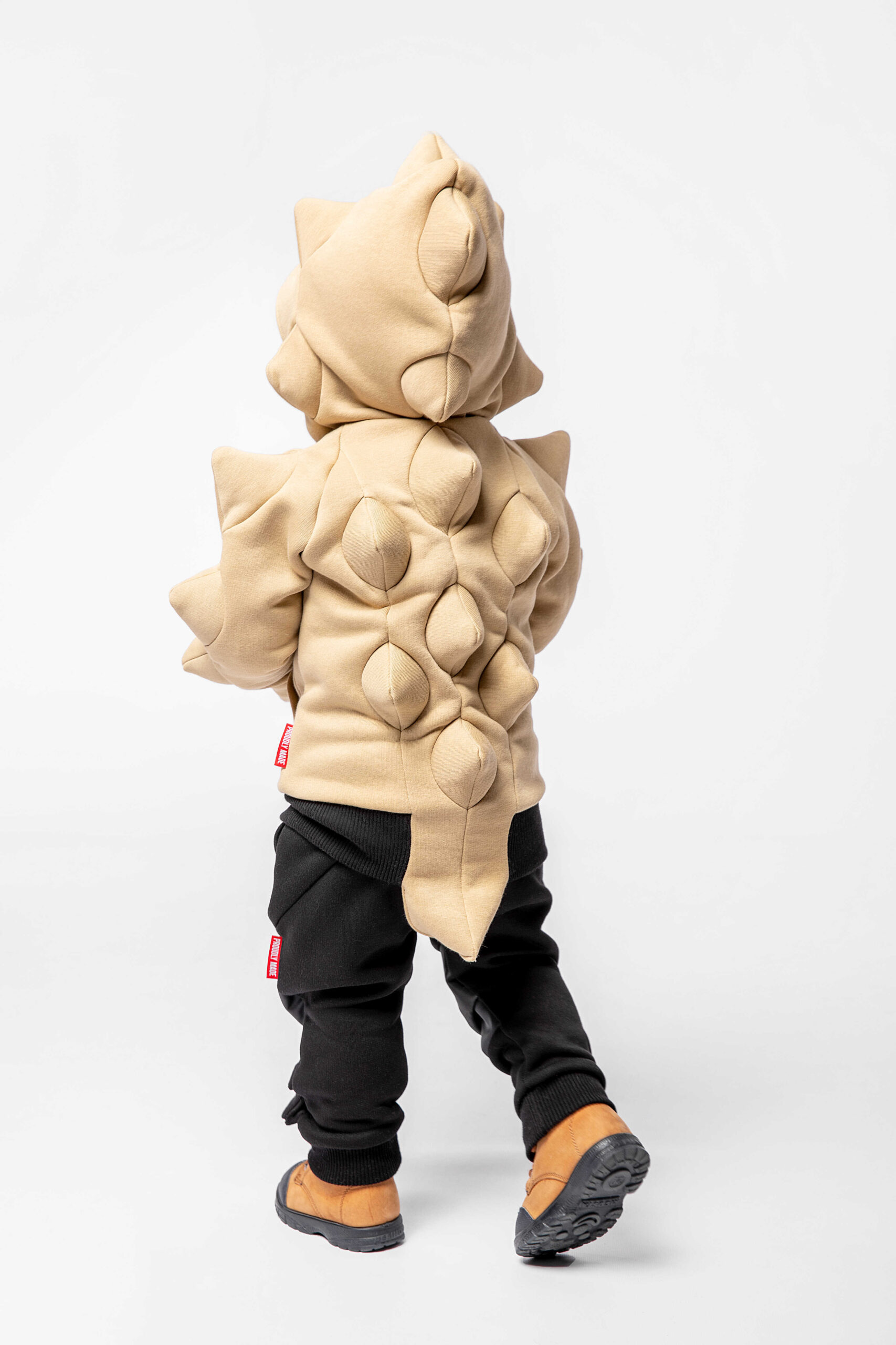 Kids Hoodie Stegosaurus. Color sand. 
Material of the hoodie – three-cord thread fabric: 77% cotton, 23% polyester.